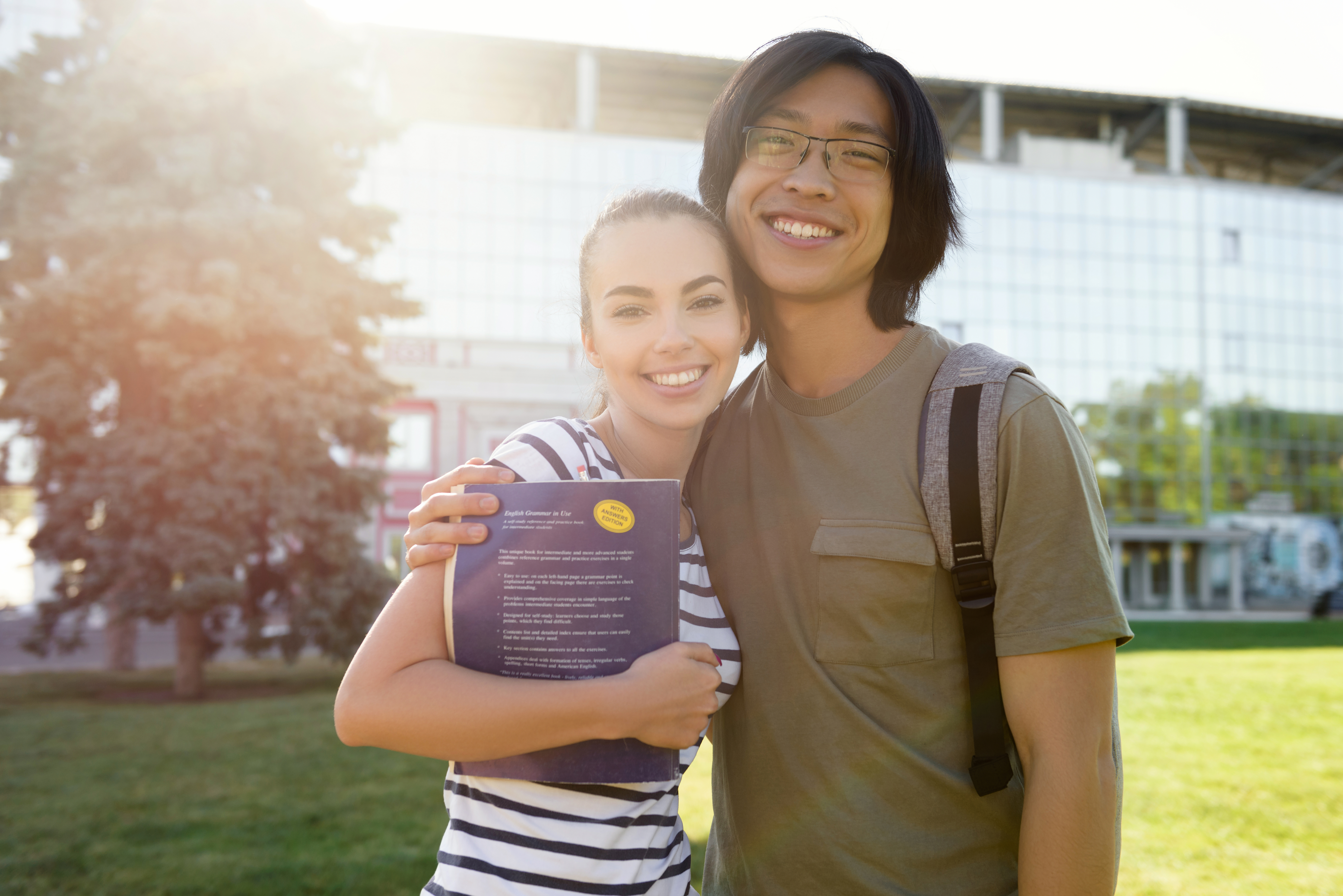 Cheerful students outdoors at a New Zealand campus.