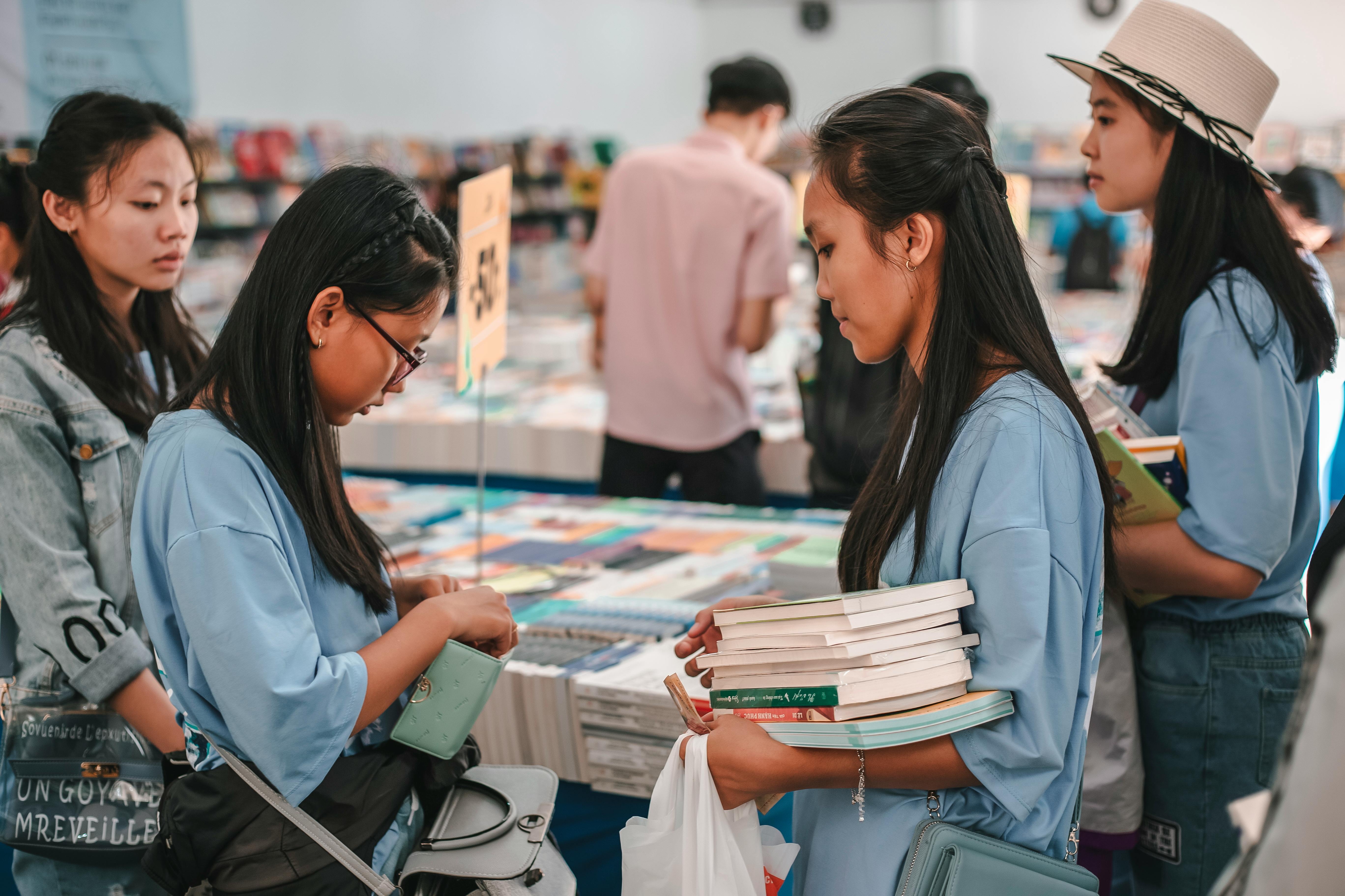 Planning study abroad from China — Student backpack bookstore browsing.